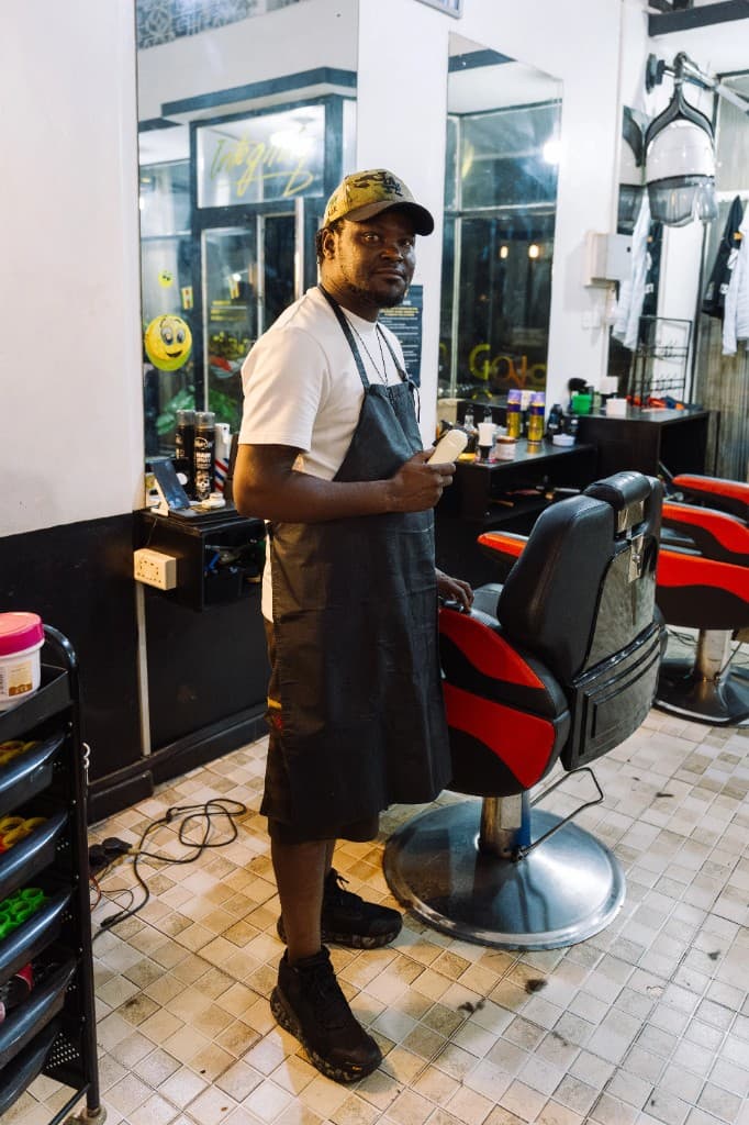 Ben Ozzly - Expert barber specializing in fades and haircuts at Golden Scissors Salon, Jinja, Uganda